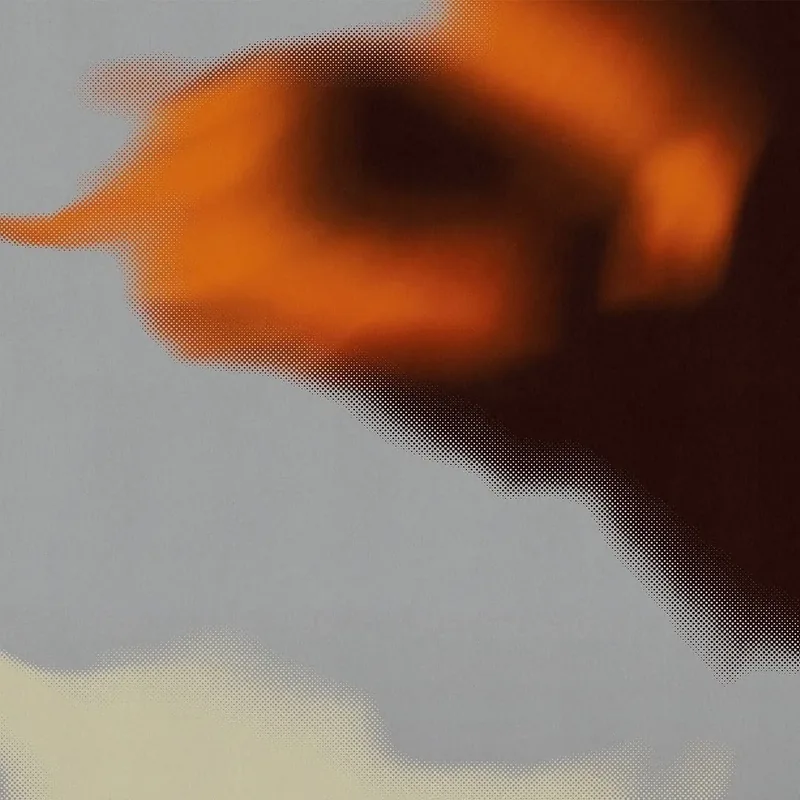 A blurred orange shape against a grey halftone ground